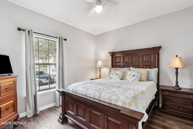 bedroom featuring a ceiling fan, baseboards, and wood finished floors
