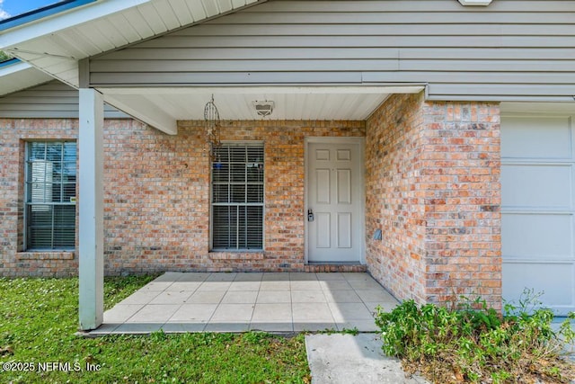 doorway to property with a garage