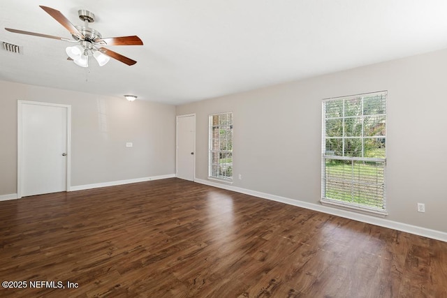 spare room featuring plenty of natural light, dark hardwood / wood-style floors, and ceiling fan