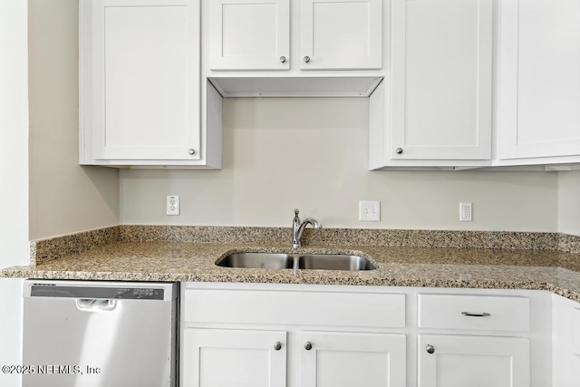 kitchen with white cabinetry, dishwasher, and sink