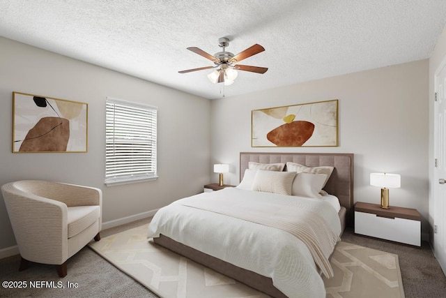 bedroom with light carpet, ceiling fan, and a textured ceiling