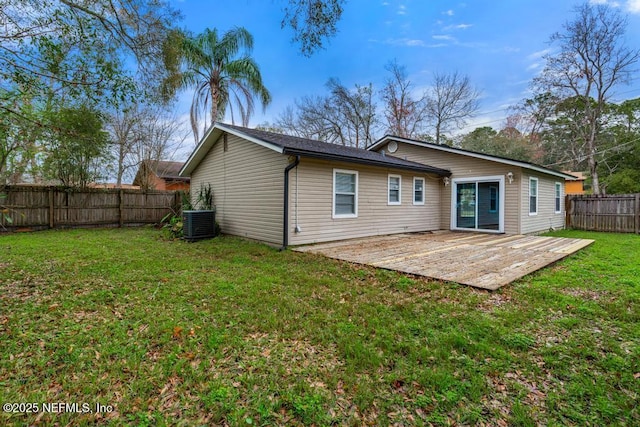 back of property with cooling unit, a fenced backyard, a lawn, and a wooden deck