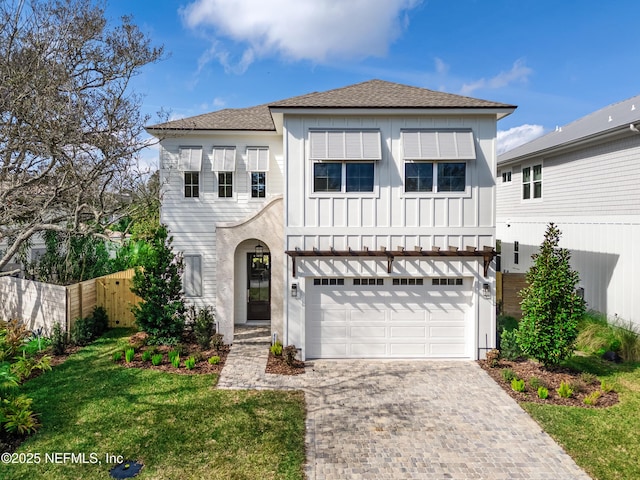 view of front of property featuring a garage and a front yard