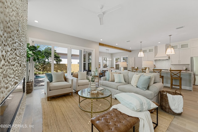 living room featuring light hardwood / wood-style floors and ceiling fan