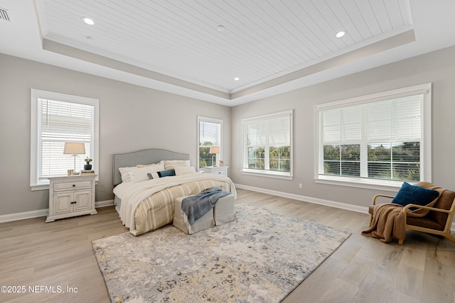 bedroom featuring ornamental molding, a tray ceiling, light hardwood / wood-style flooring, and wooden ceiling