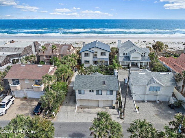 bird's eye view featuring a beach view, a water view, and a residential view