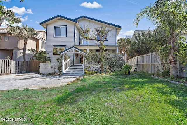 view of front of house featuring a front yard and fence