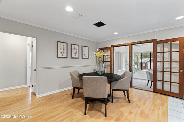 dining space with crown molding and hardwood / wood-style flooring