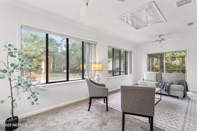 sunroom featuring ceiling fan