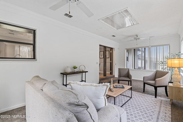 carpeted living room with crown molding and ceiling fan