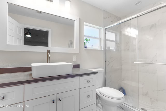 full bathroom with toilet, a marble finish shower, and vanity