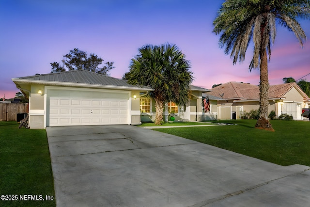 single story home featuring concrete driveway, a yard, an attached garage, and stucco siding