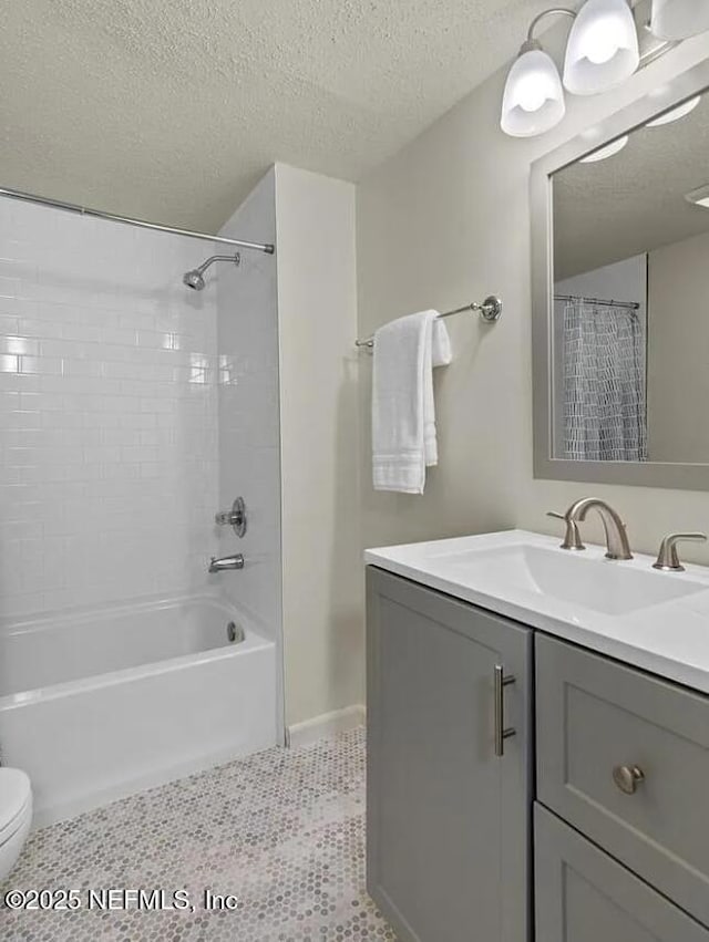 bathroom with shower / bath combo with shower curtain, a textured ceiling, vanity, and toilet