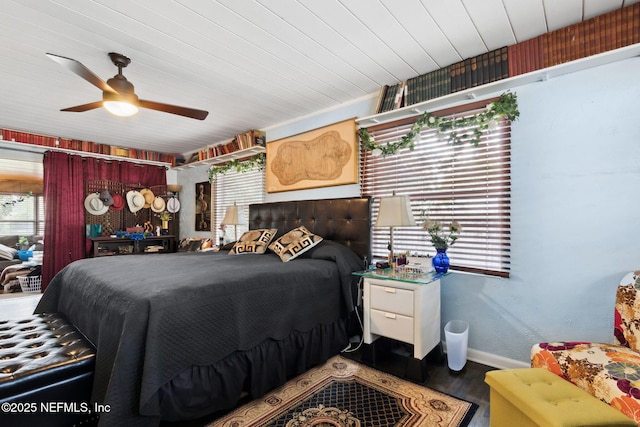 bedroom featuring multiple windows, hardwood / wood-style flooring, and ceiling fan