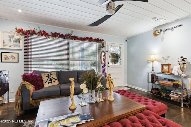 living room featuring ceiling fan, dark hardwood / wood-style flooring, and wooden ceiling