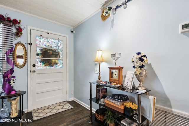 foyer featuring dark hardwood / wood-style flooring and crown molding