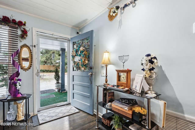 foyer featuring ornamental molding and dark hardwood / wood-style floors