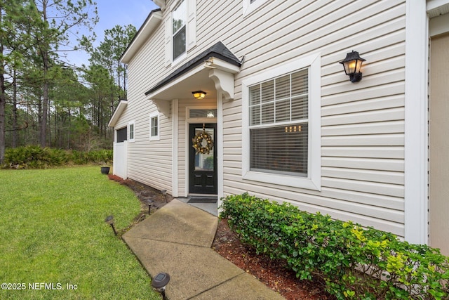 entrance to property with a yard