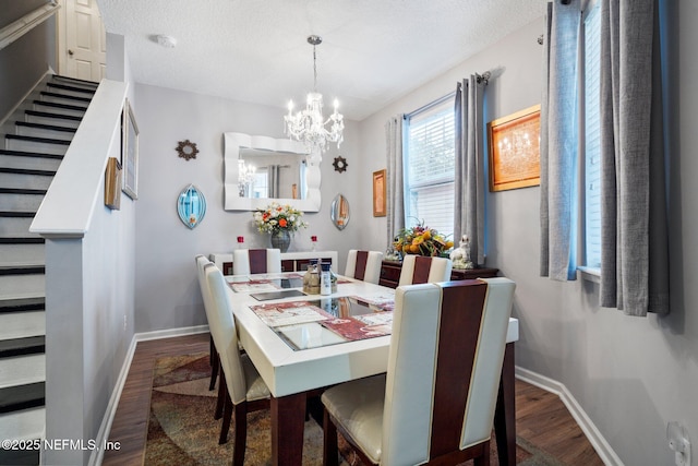 dining area with a textured ceiling, stairway, baseboards, and wood finished floors