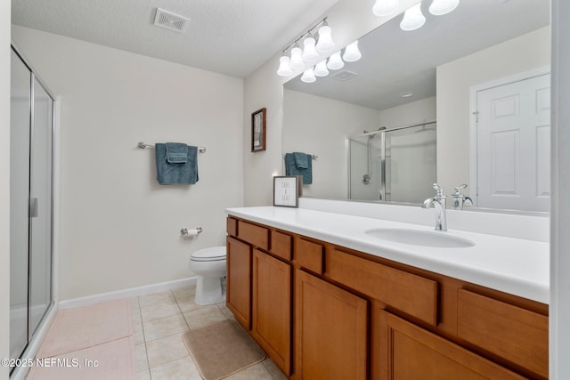 bathroom featuring visible vents, a stall shower, vanity, a textured ceiling, and tile patterned flooring