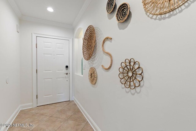 doorway with light tile patterned floors and crown molding