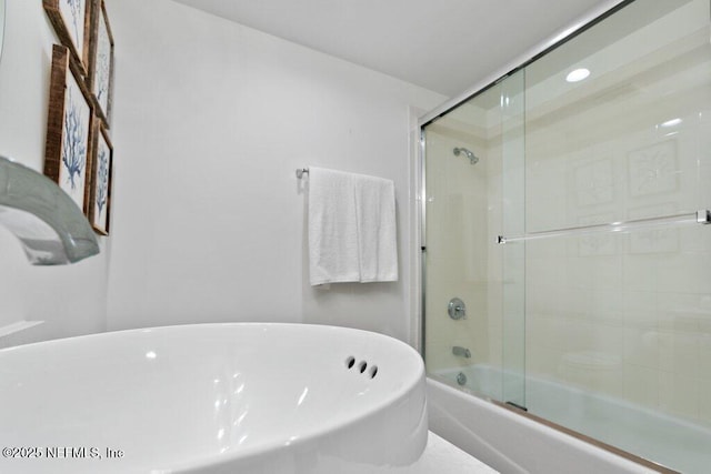 bathroom featuring shower / bath combination with glass door