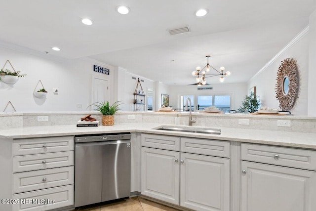 kitchen with light stone counters, sink, and stainless steel dishwasher