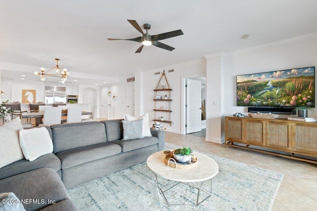 living room with light tile patterned flooring, ceiling fan with notable chandelier, and crown molding