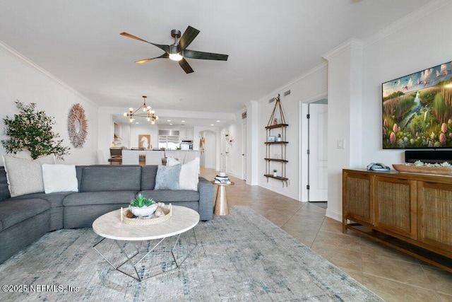 living room featuring crown molding, ceiling fan with notable chandelier, and light tile patterned floors