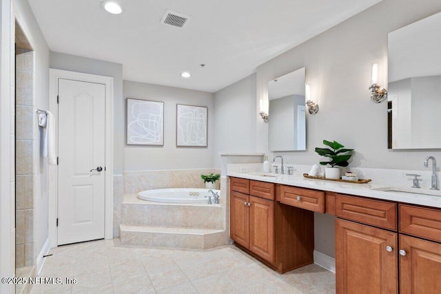 bathroom with vanity, tile patterned floors, and tiled bath