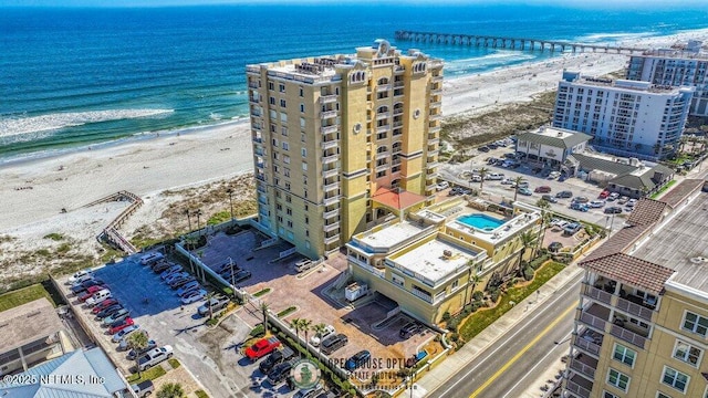 drone / aerial view featuring a water view and a beach view