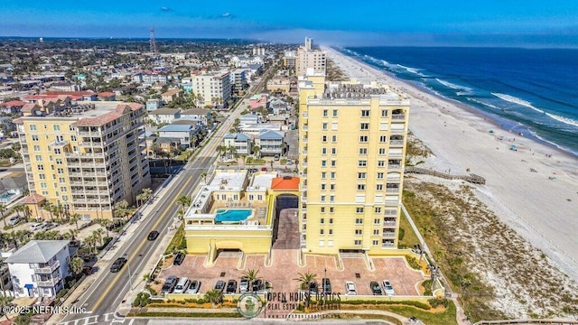 bird's eye view featuring a view of the beach and a water view