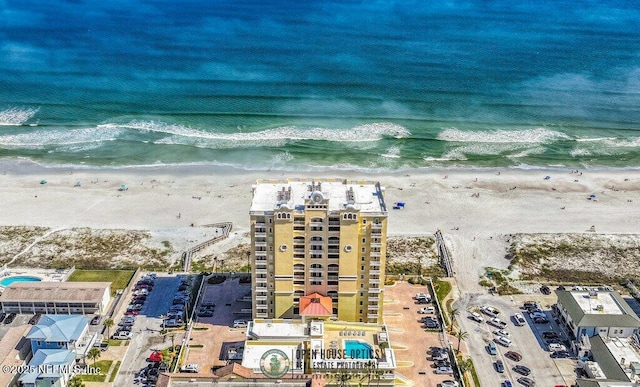 birds eye view of property with a beach view and a water view