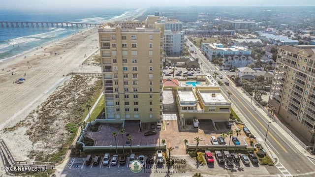 bird's eye view featuring a water view and a beach view