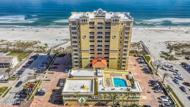 birds eye view of property with a view of the beach and a water view