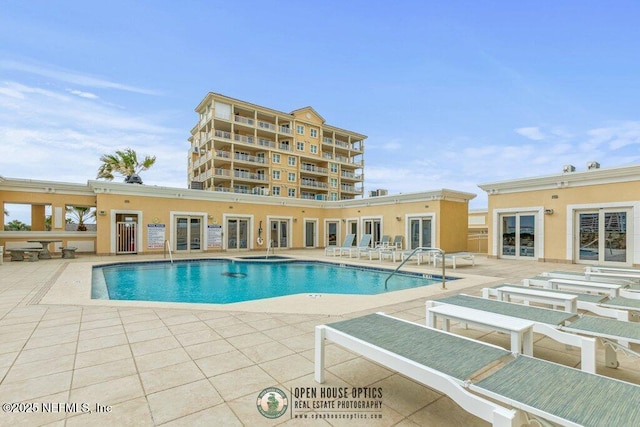 view of pool featuring a hot tub and a patio