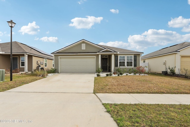 ranch-style house with a garage and a front lawn