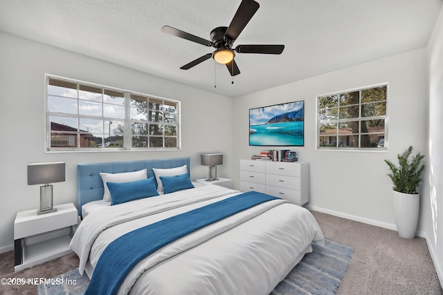 bedroom featuring ceiling fan, carpet, and a textured ceiling