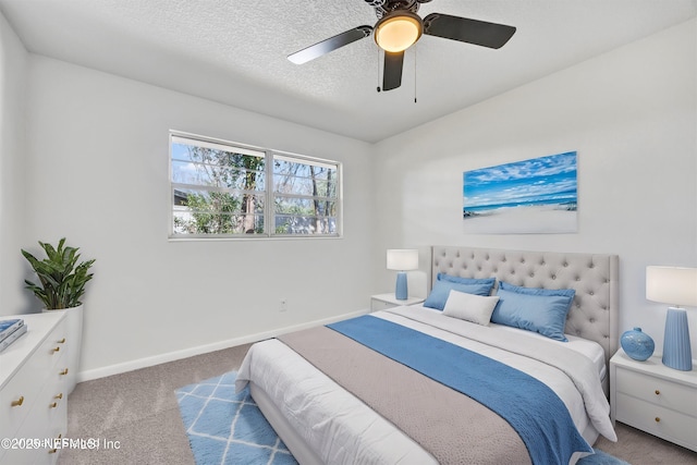 bedroom featuring ceiling fan, light colored carpet, and a textured ceiling