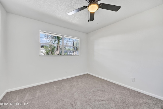 carpeted empty room with ceiling fan and a textured ceiling