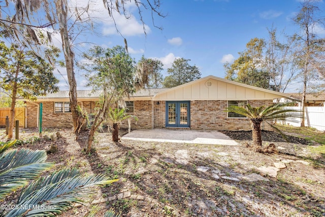 rear view of property with a patio area and french doors