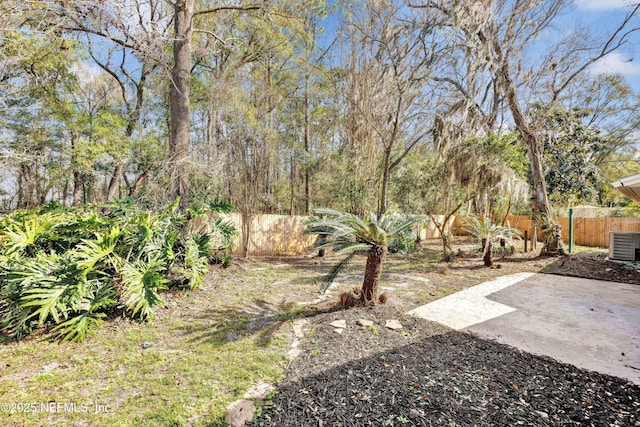 view of yard with central AC and a patio