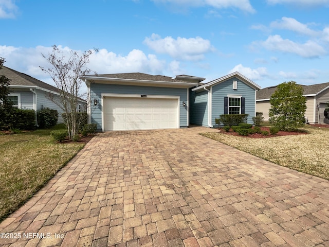 ranch-style house with a garage and a front lawn