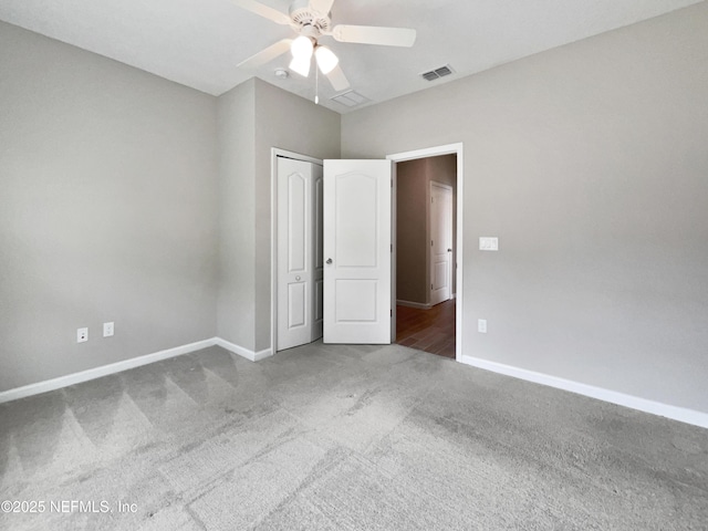 unfurnished bedroom with carpet, ceiling fan, and a closet