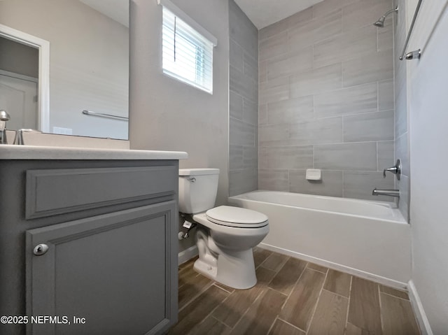 full bathroom featuring vanity, toilet, and tiled shower / bath