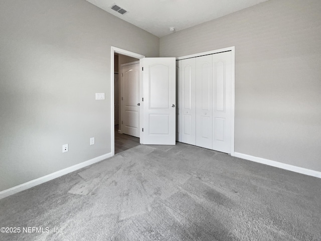 unfurnished bedroom with carpet floors and a closet