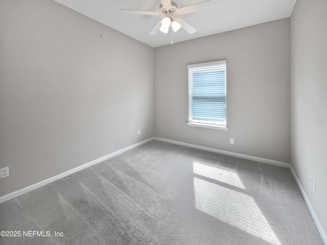 unfurnished room with ceiling fan and carpet flooring