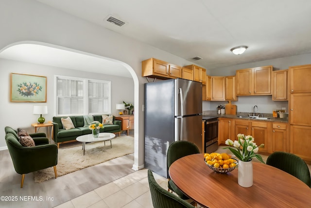 kitchen featuring sink, appliances with stainless steel finishes, light brown cabinets, and light tile patterned floors