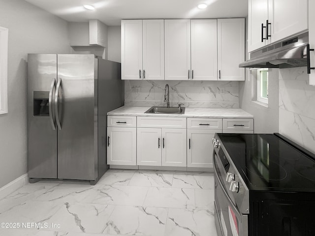 kitchen featuring decorative backsplash, white cabinets, appliances with stainless steel finishes, under cabinet range hood, and a sink