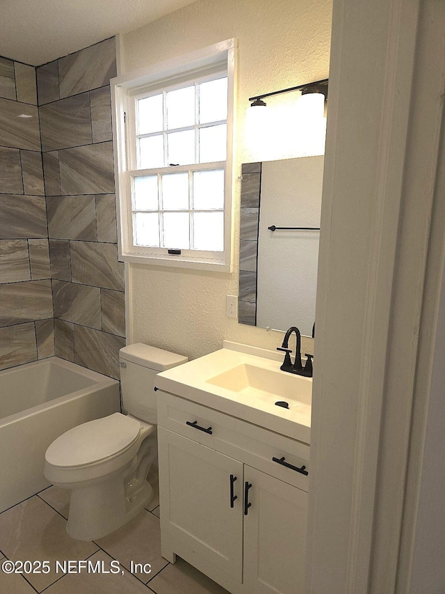 full bathroom with tiled shower / bath, vanity, toilet, and tile patterned flooring